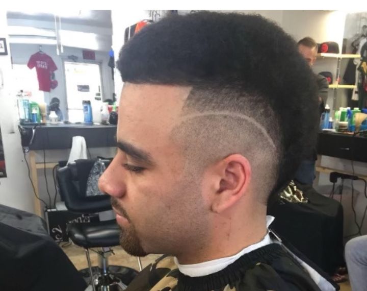 young boy getting a haircut at a barbershop